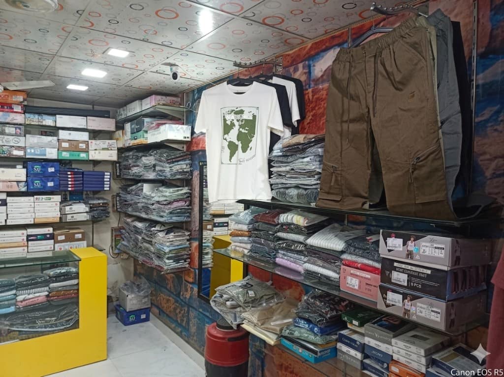 Shelving with tees, cargos, and boxed inventory